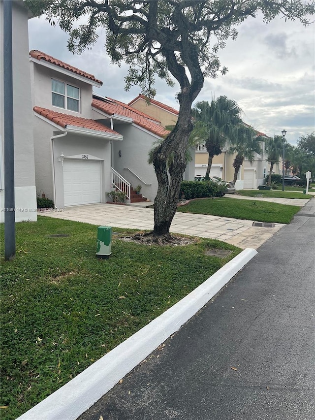 view of front of house with a front yard and a garage