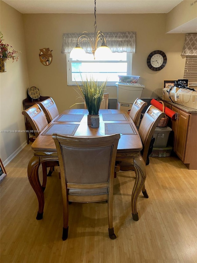 dining room with a chandelier and light hardwood / wood-style flooring