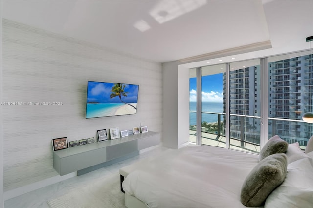 bedroom featuring access to outside and a wall of windows