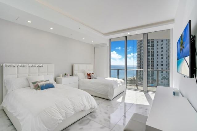 bedroom with expansive windows and access to outside