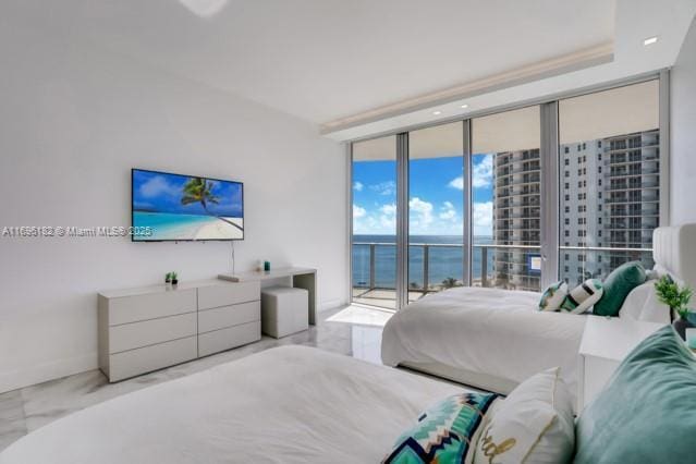 bedroom featuring access to outside and floor to ceiling windows