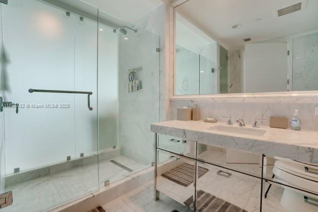 bathroom with vanity, toilet, and an enclosed shower