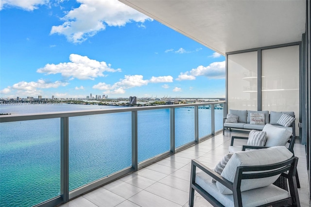 balcony with outdoor lounge area and a water view