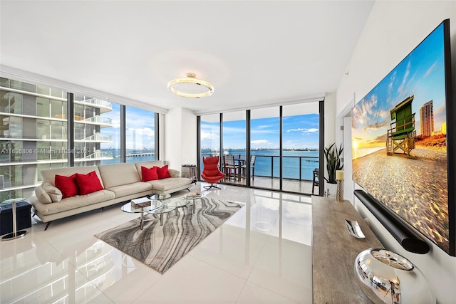 living room featuring tile patterned floors, expansive windows, and a water view