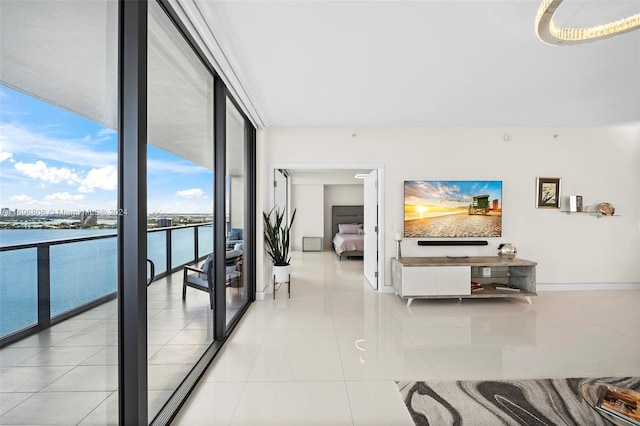 interior space with a water view and expansive windows