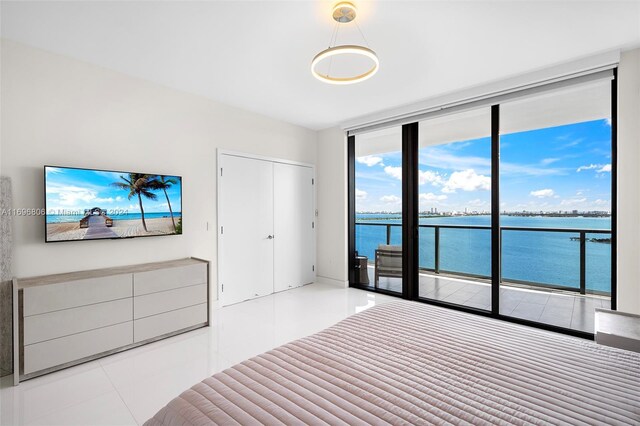 788 NE 23rd St Unit 2102, Miami, FL 33137 - unfurnished bedroom featuring a wall of windows, access to outside, tile patterned flooring, and a water view