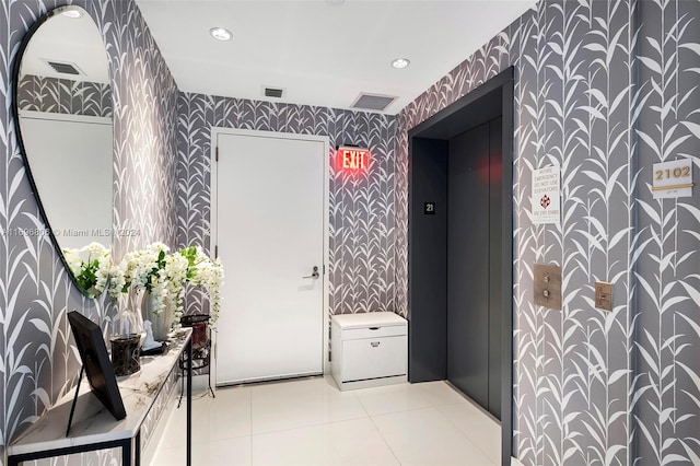 interior space with elevator and tile patterned flooring