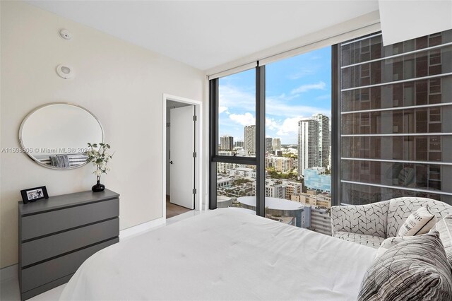 788 NE 23rd St Unit 2102, Miami, FL 33137 - bedroom featuring a wall of windows, a city view, and wood finished floors