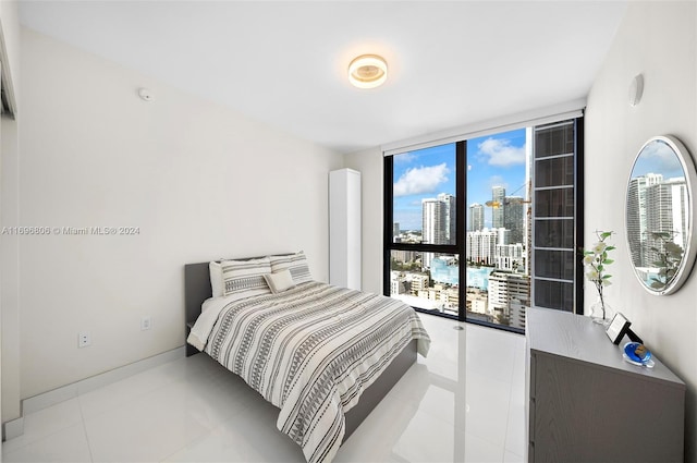 788 NE 23rd St Unit 2102, Miami, FL 33137 - tiled bedroom featuring a view of city, floor to ceiling windows, and baseboards