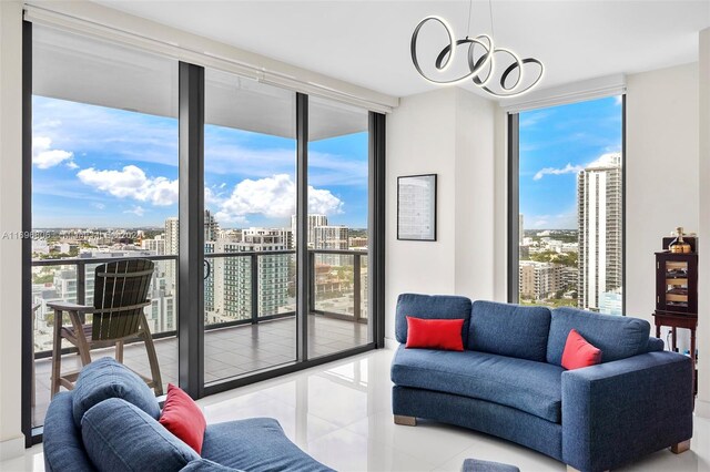 788 NE 23rd St Unit 2102, Miami, FL 33137 - living room featuring expansive windows, a chandelier, a view of city, and tile patterned flooring