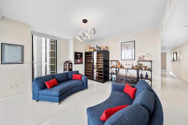 living room with light tile patterned floors and a notable chandelier