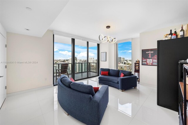 788 NE 23rd St Unit 2102, Miami, FL 33137 - living room with expansive windows, a chandelier, light tile patterned floors, a view of city, and baseboards