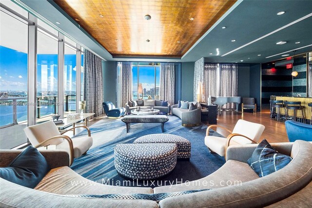 788 NE 23rd St Unit 2102, Miami, FL 33137 - living area featuring wooden ceiling, wood finished floors, a wall of windows, healthy amount of natural light, and a view of city