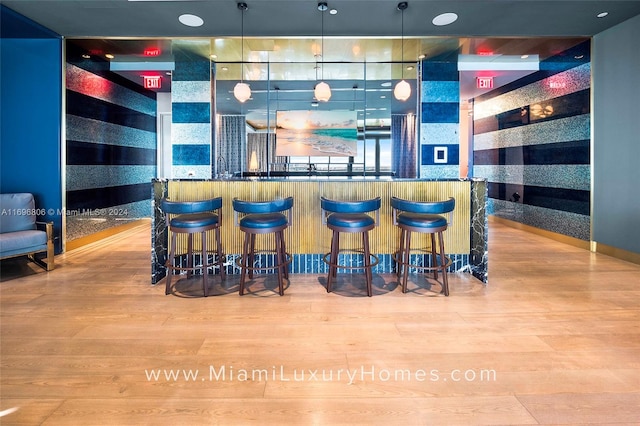 bar featuring pendant lighting and light wood-type flooring