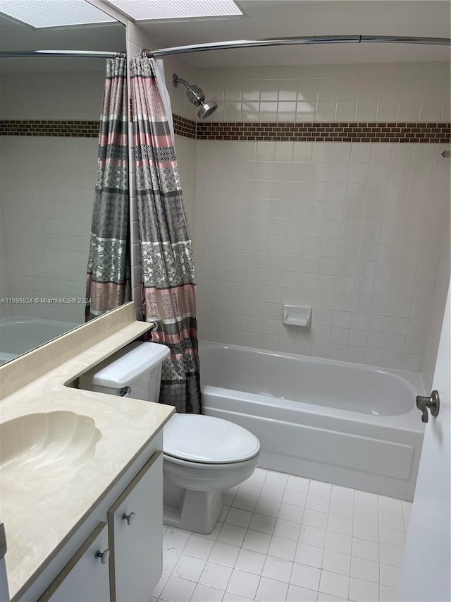 full bathroom featuring tile patterned floors, vanity, toilet, and shower / tub combo with curtain