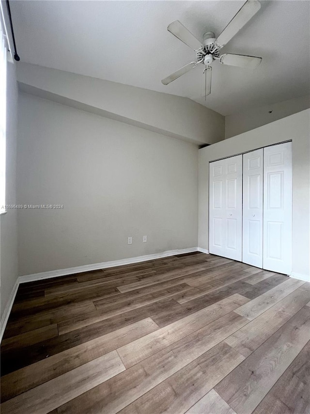 unfurnished bedroom with ceiling fan, a closet, and light hardwood / wood-style flooring