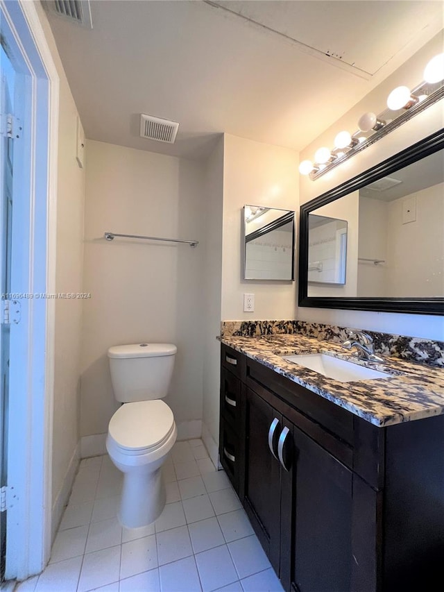 bathroom with tile patterned floors, vanity, and toilet