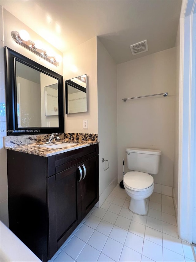 bathroom with tile patterned floors, vanity, and toilet