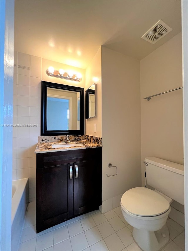 bathroom with tile patterned flooring, vanity, and toilet