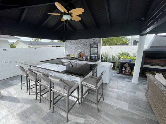 view of patio / terrace with a bar and ceiling fan