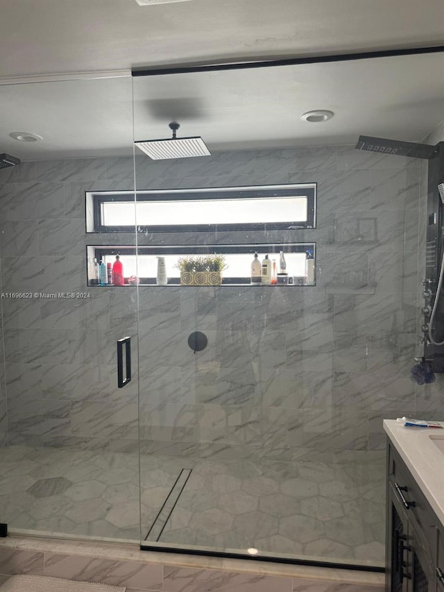 bathroom featuring vanity and an enclosed shower