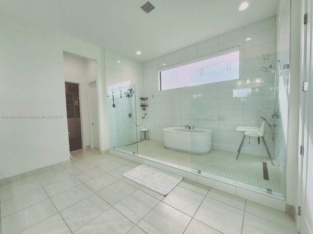 bathroom with a stall shower, visible vents, tile patterned flooring, a freestanding tub, and recessed lighting