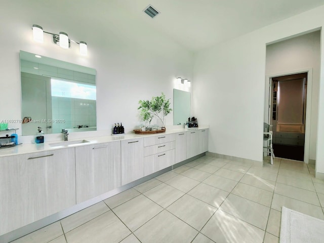 full bathroom featuring tile patterned flooring, visible vents, a sink, and double vanity