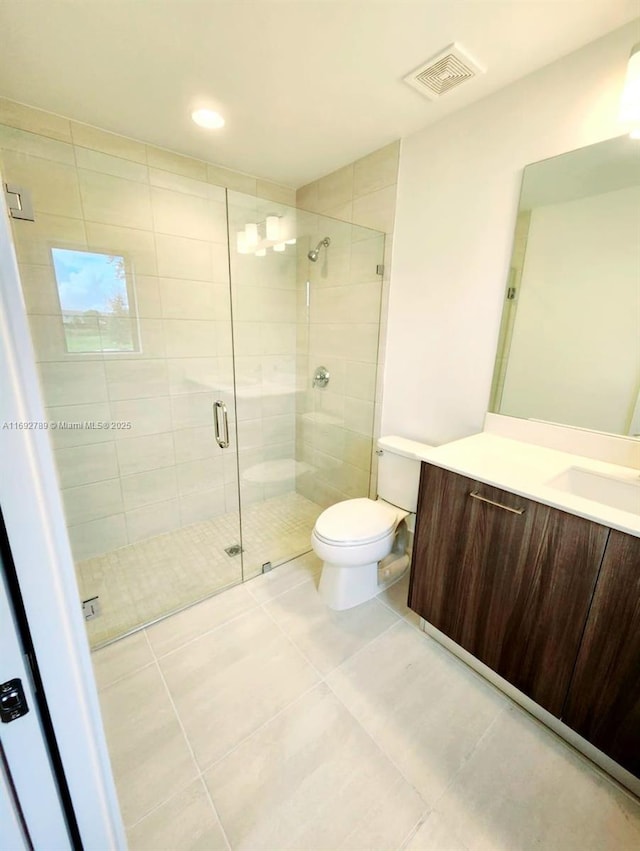 full bathroom featuring tile patterned flooring, toilet, vanity, visible vents, and a shower stall