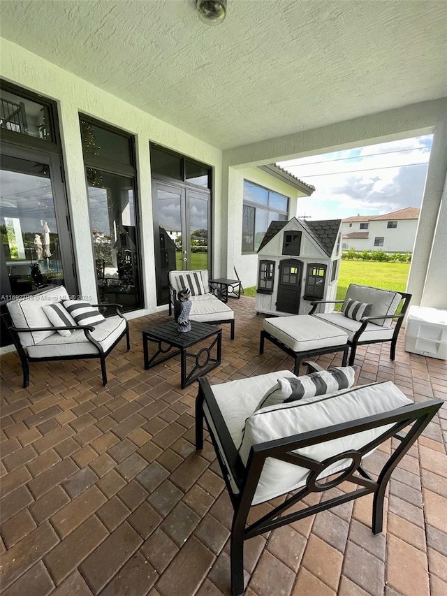 view of patio / terrace featuring an outdoor living space and an outdoor structure