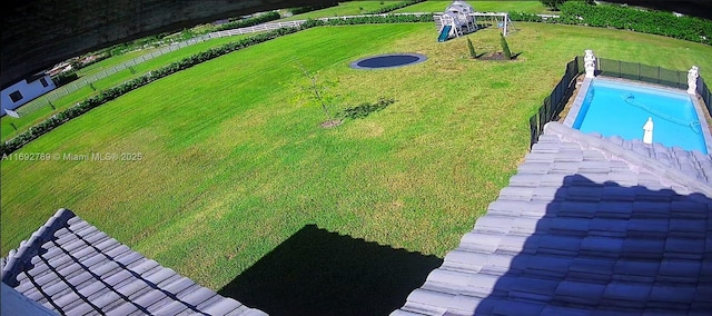 pool with playground community and a yard