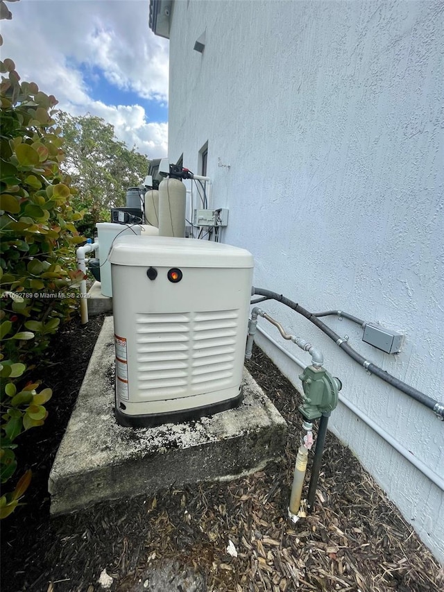 exterior details with a power unit and stucco siding