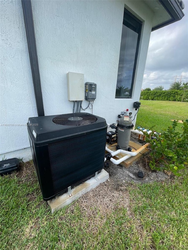 exterior details with central AC and stucco siding