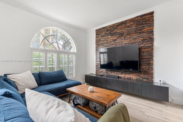 living room with light wood-type flooring and crown molding