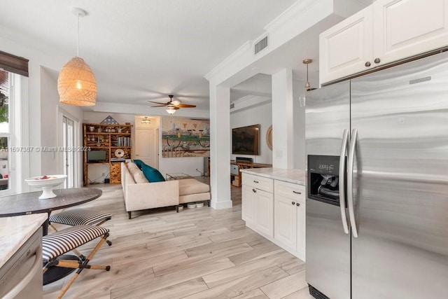 kitchen featuring pendant lighting, white cabinets, ceiling fan, stainless steel fridge, and light hardwood / wood-style floors