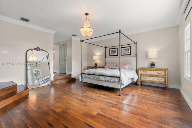 bedroom with a chandelier, crown molding, and dark wood-type flooring