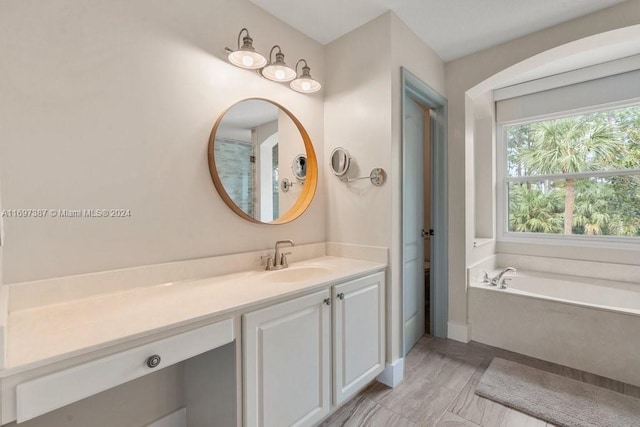 bathroom featuring vanity and a tub