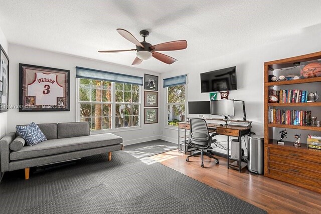 office area featuring ceiling fan, a textured ceiling, and hardwood / wood-style flooring