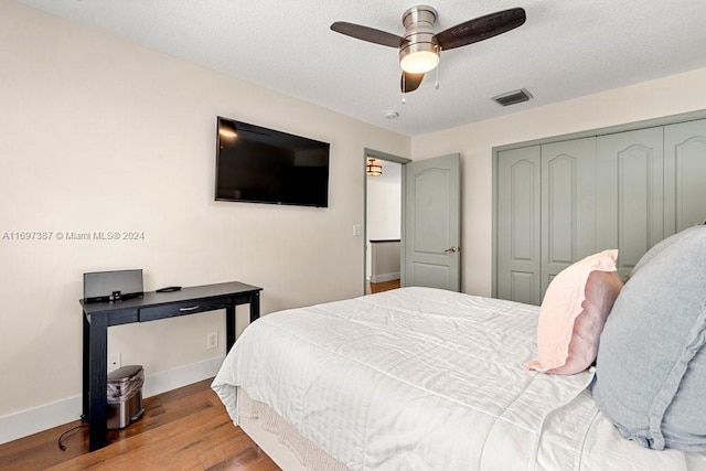 bedroom featuring hardwood / wood-style floors, a closet, and ceiling fan