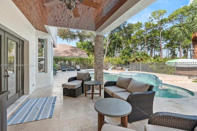 view of patio / terrace featuring an outdoor living space, a fenced in pool, and ceiling fan