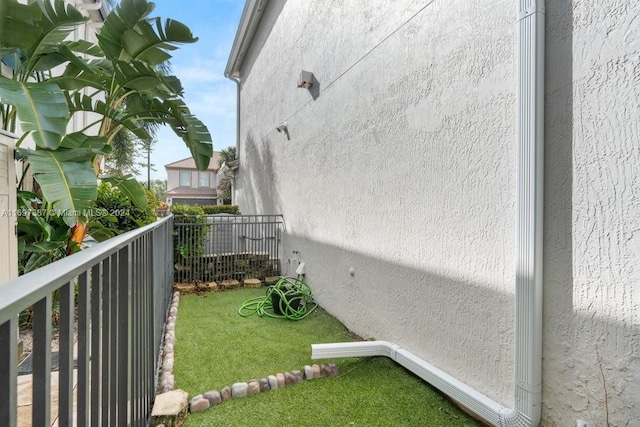 exterior space featuring a balcony and a yard