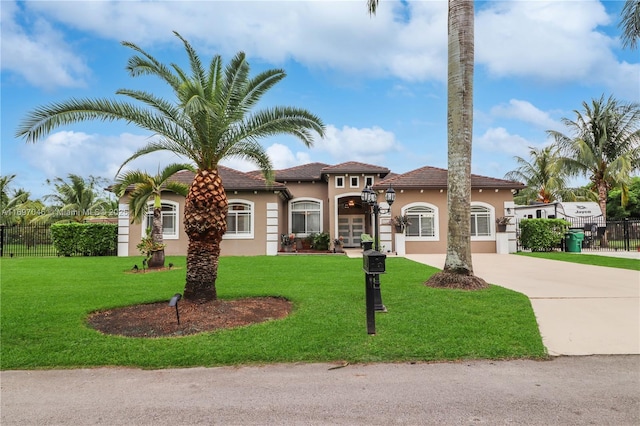 mediterranean / spanish home with a front yard