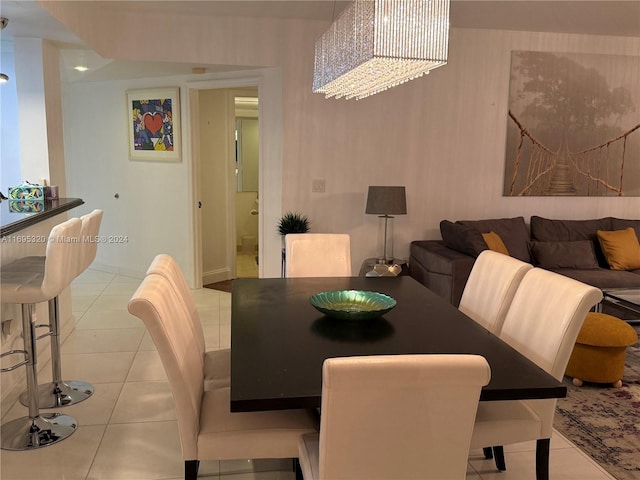 tiled dining room featuring an inviting chandelier