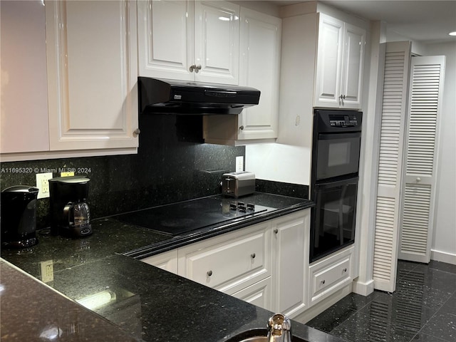 kitchen with backsplash, white cabinets, black appliances, and range hood