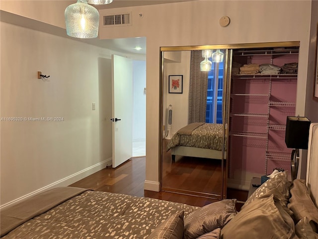 bedroom featuring dark hardwood / wood-style flooring and a closet