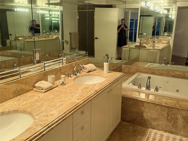 bathroom with vanity, a relaxing tiled tub, and tile patterned floors