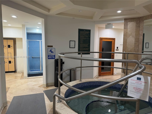 workout room featuring coffered ceiling