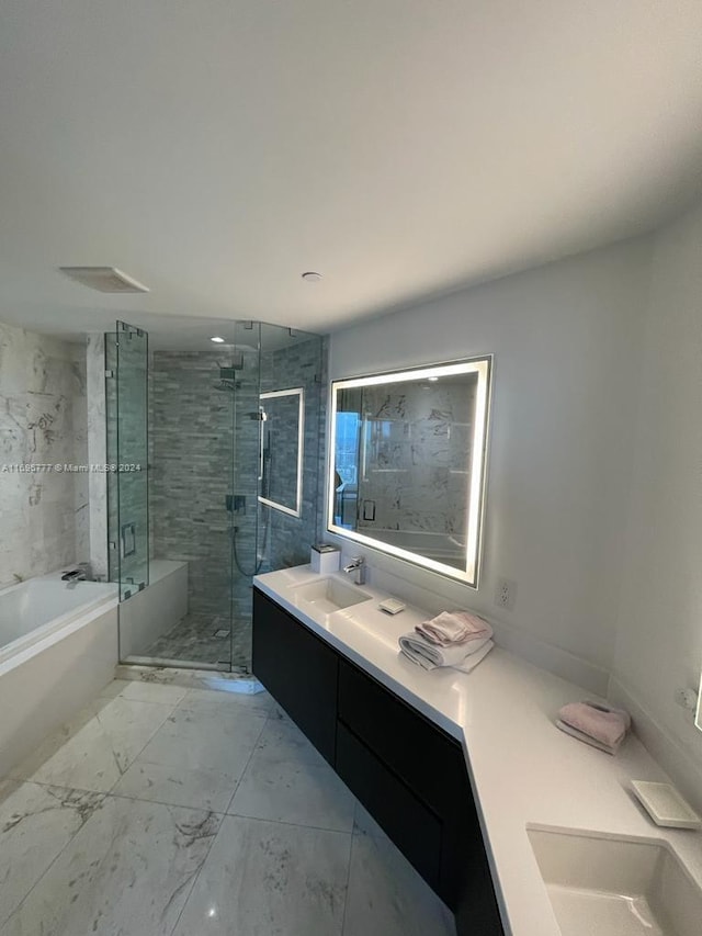 bathroom with vanity and separate shower and tub