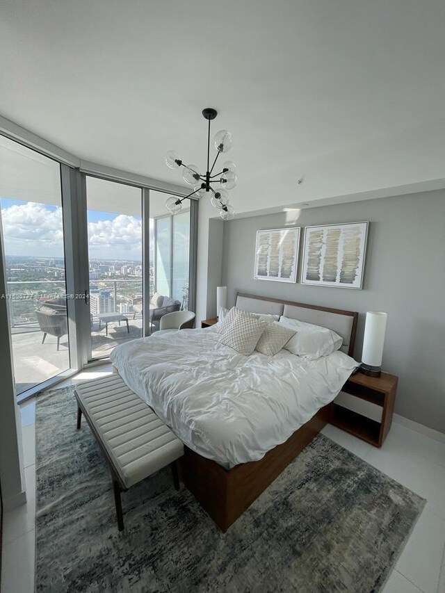 bedroom with access to outside, multiple windows, tile patterned floors, and a chandelier