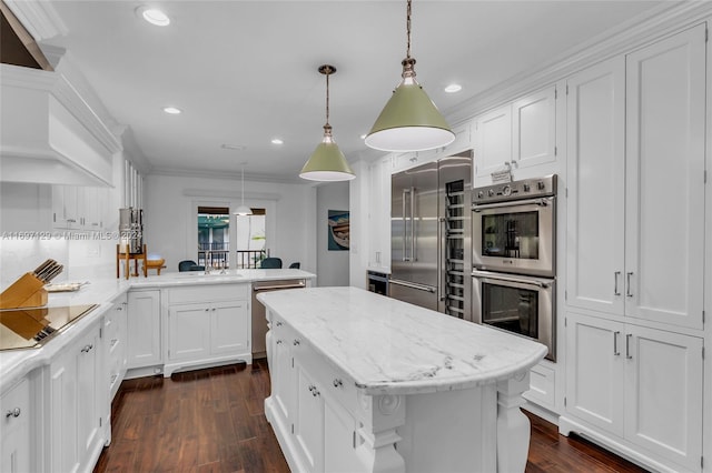 kitchen with a center island, crown molding, decorative light fixtures, kitchen peninsula, and stainless steel appliances