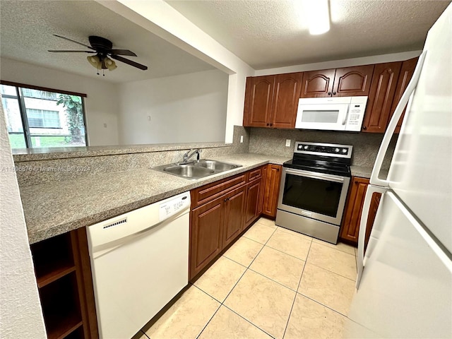 kitchen featuring ceiling fan, sink, a textured ceiling, white appliances, and light tile patterned flooring